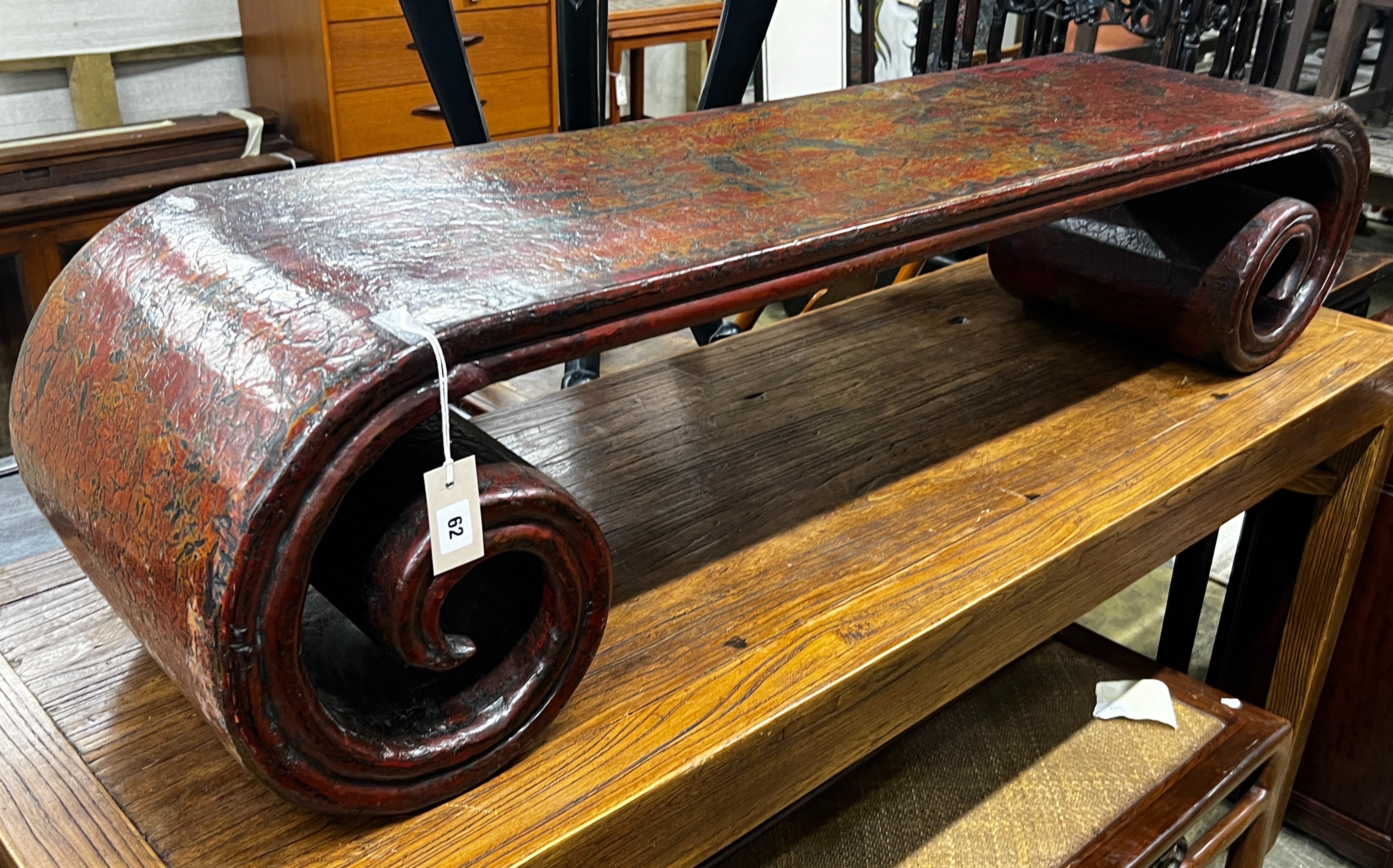 A Chinese lacquer scroll end low table, width 146cm, depth 35cm, height 33cm